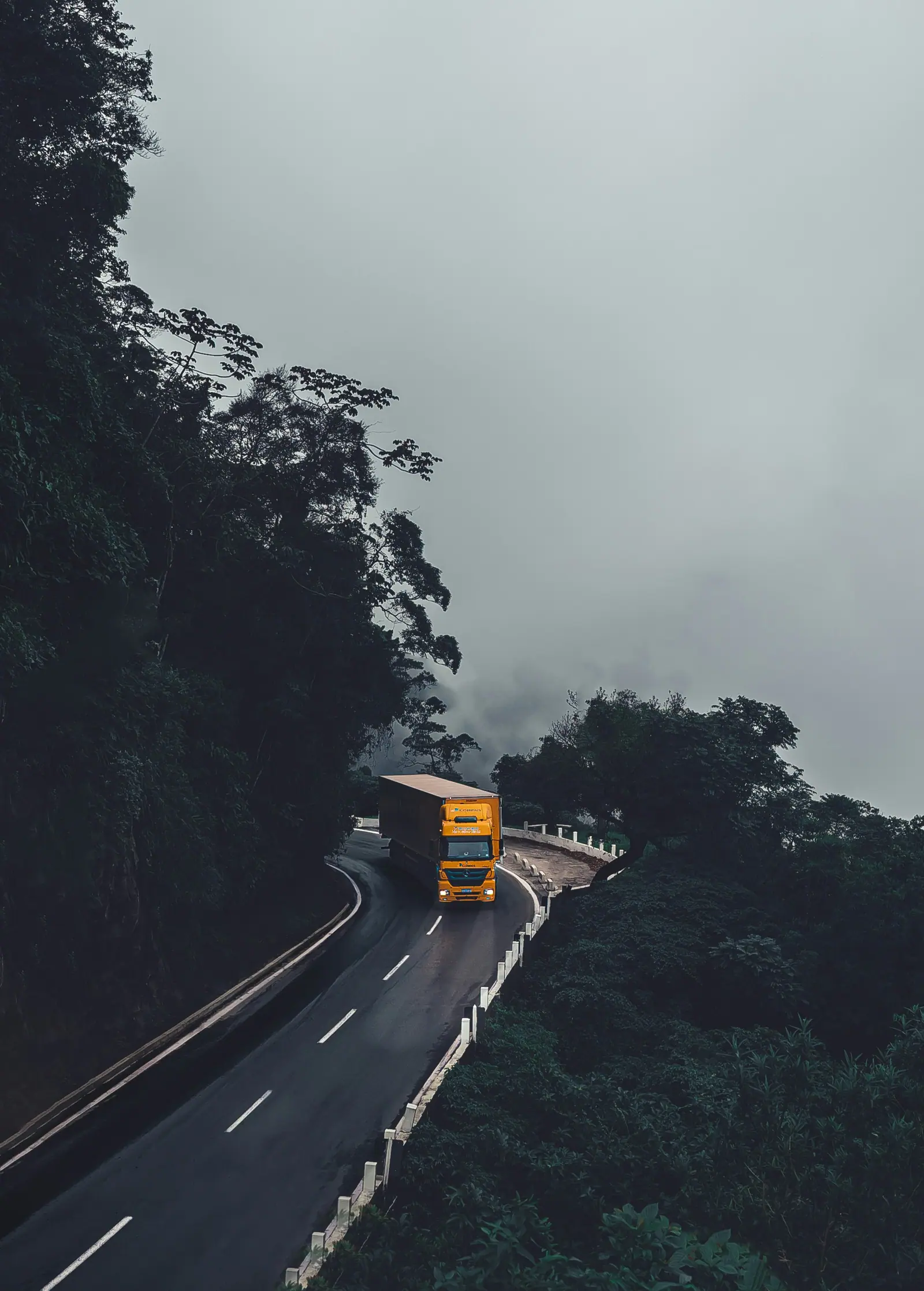 Trucks on a highway at dusk